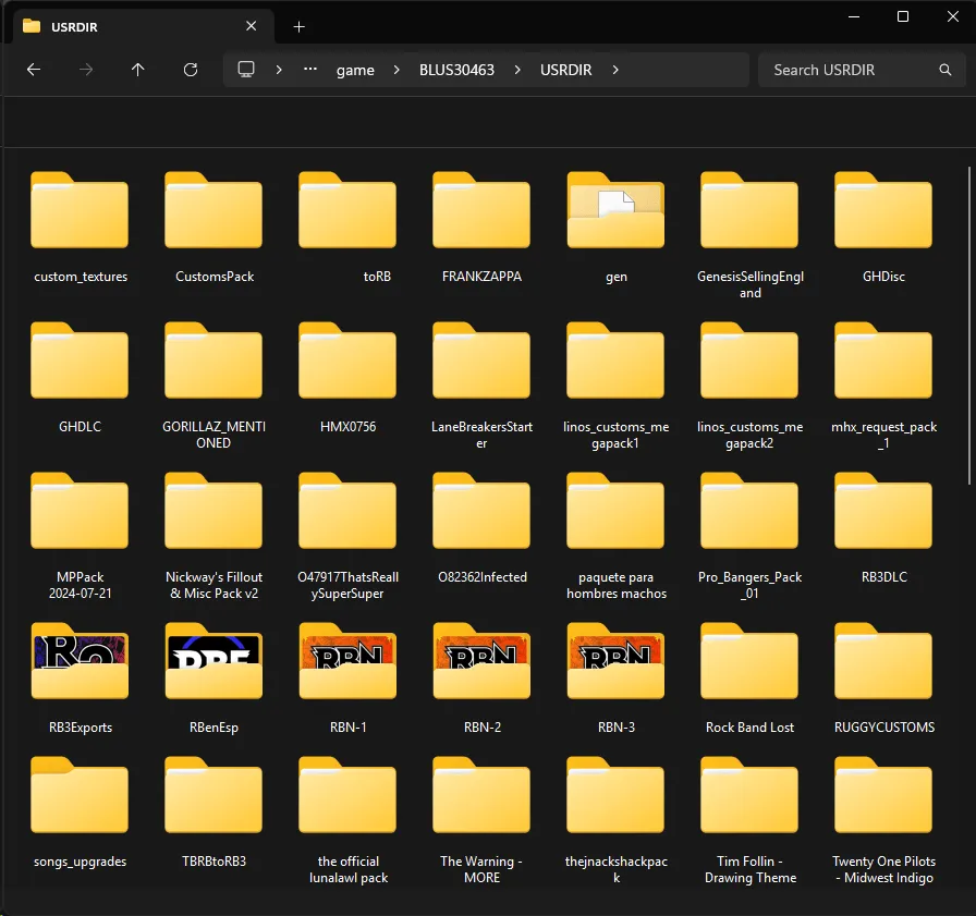 A Windows Explorer window. It's showing the USRDIR of Rock Band 3, with various folders that are music packs.