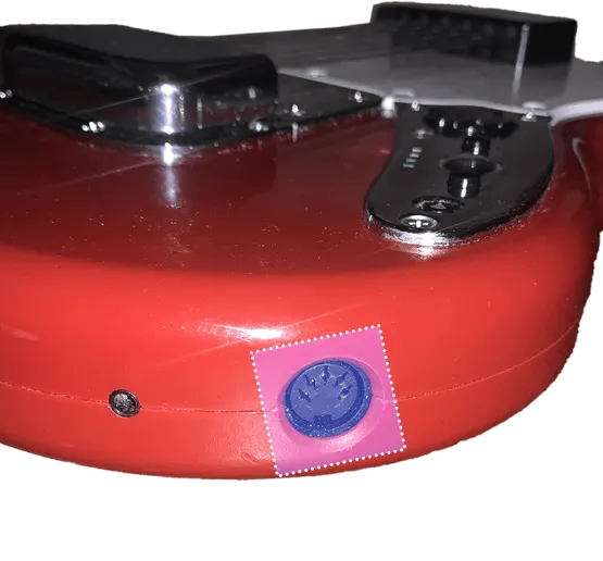 A Rock Band 3 Mustang Pro Guitar showing a 5-DIN MIDI output highlighted in blue with a dotted white outline.