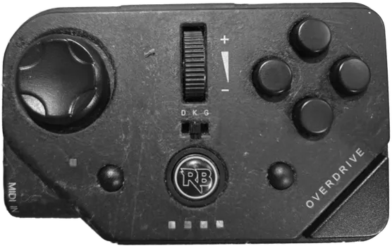 A MIDI PRO Adapter with the middle switch set to 'K'.
