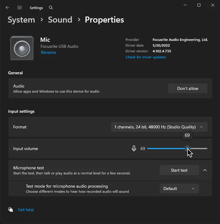 Windows' Sound settings within an input device's properties. A cursor is adjusting the input volume for an input device named 'Mic'.