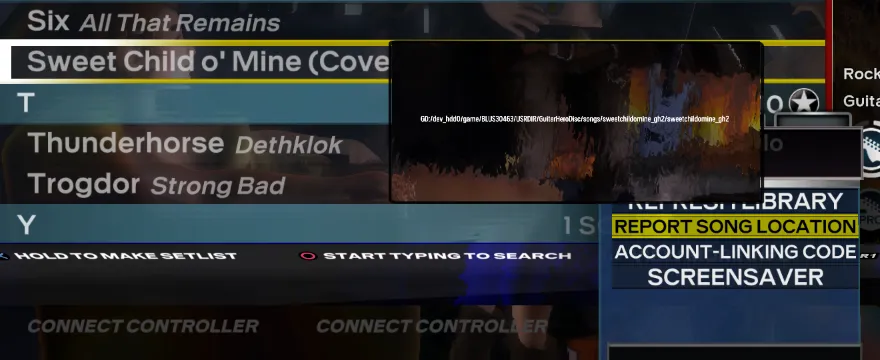 Rock Band 3 Deluxe with a song highlighted and with 'Report Song Location' being selected. A popup with the song's directory is displayed.